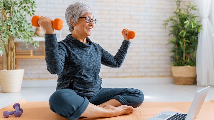 woman-following-a-virtual-workout-on-her-laptop