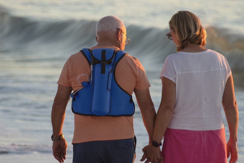 walking along beach with oxygen vest